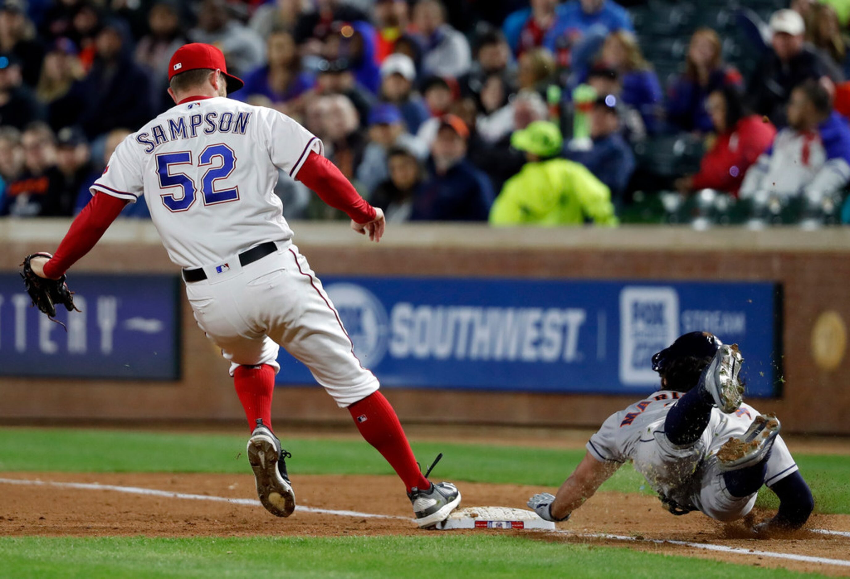 Texas Rangers relief pitcher Adrian Sampson throws to the Houston Astros in the fourth...