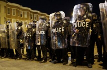  FILE - In this April 28, 2015 file photo, police stand in formation as a curfew approache...