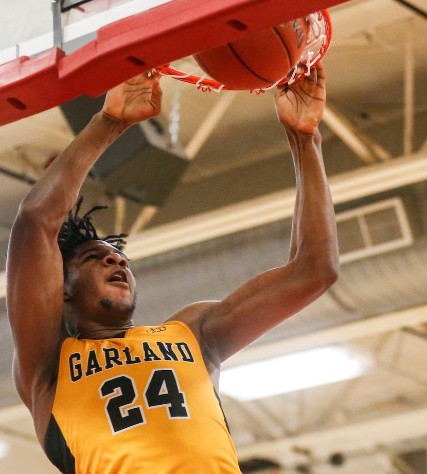 Garland High School Zuby Ejiofor (24) dunks the ball during the second quarter of the game...