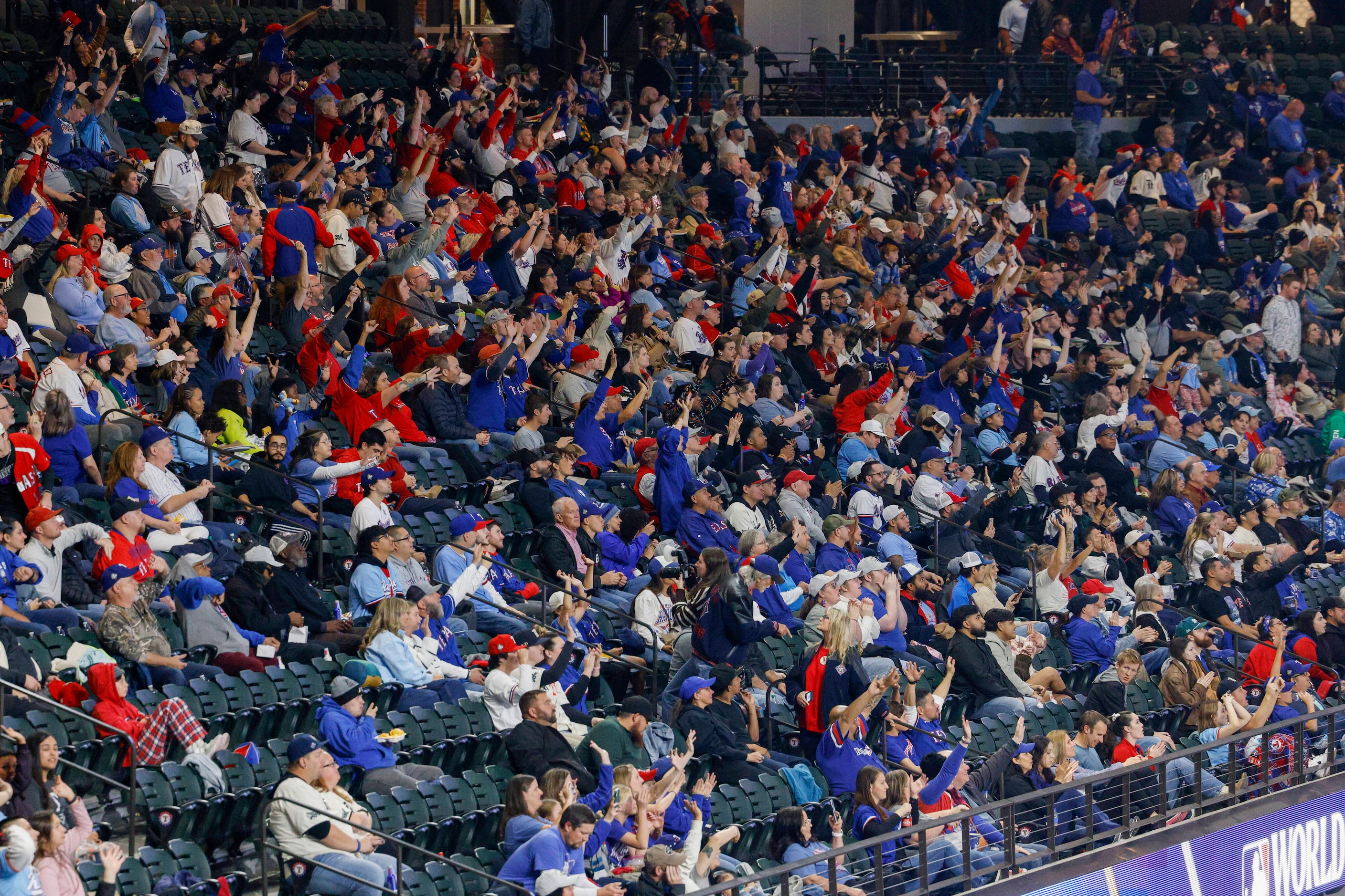 Texas Rangers fans cheer before Game 3 of the World Series at a watch party at Globe Life...