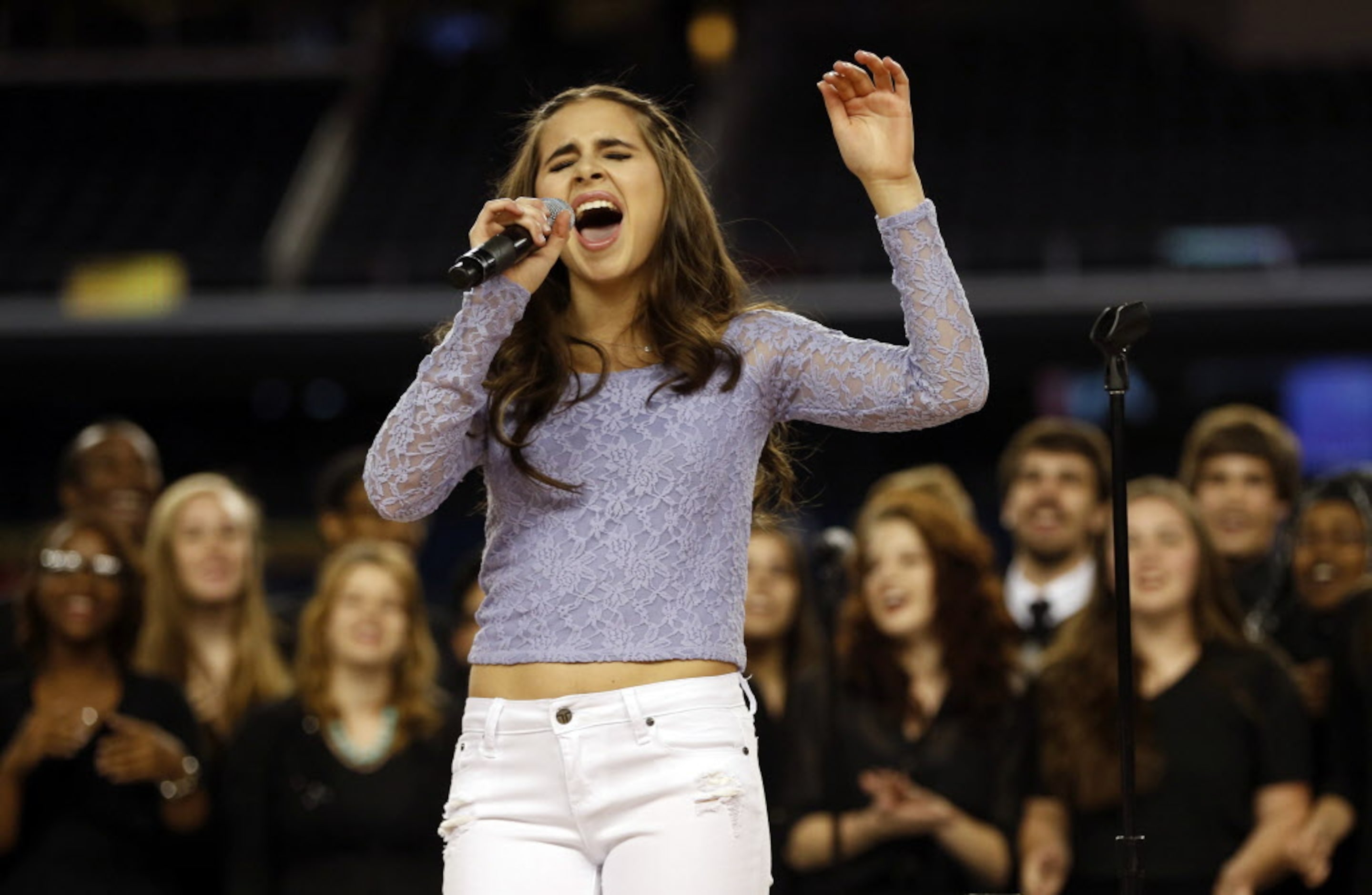 Carly Rose Sonenclar sings as the Arlington High School Choir sings backup during a...