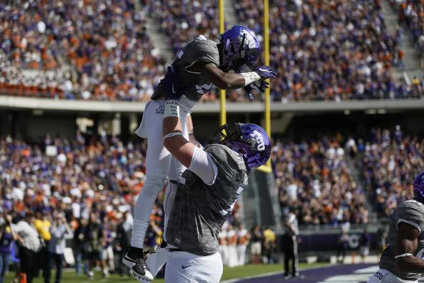 TCU wide receiver KaVontae Turpin (25) is congratulated by offensive guard Bobby Thompson...