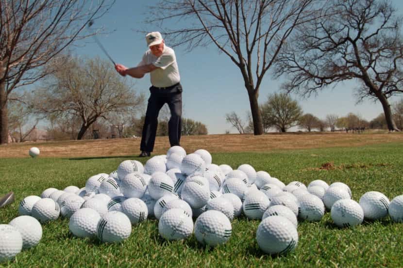 A member works on his game on the driving range at Preston Trail Country Club in Dallas....