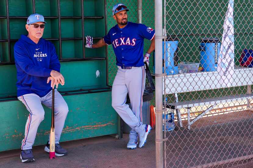 Texas Rangers manager Bruce Bochy watches from a dugout with infielder Marcus Semien during...