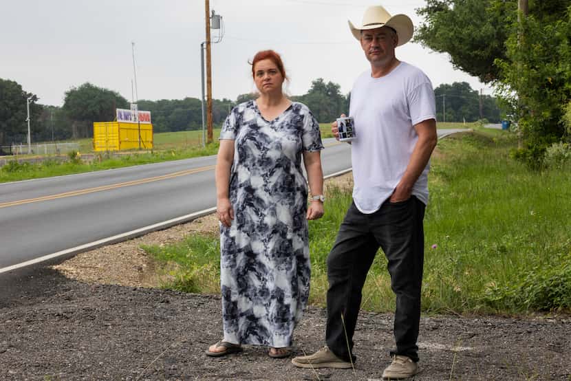 Neighbors Kate Zimmerman (left) and Neil Foreman stand outside of Foreman’s home with Joe...