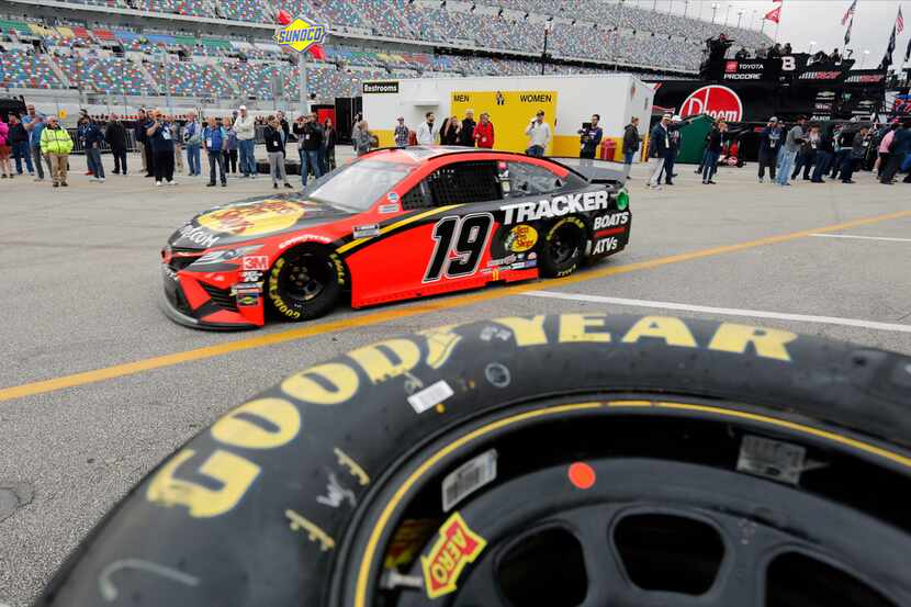 Martin Truex Jr. (19) heads to a practice session for the NASCAR Daytona 500 auto race at...