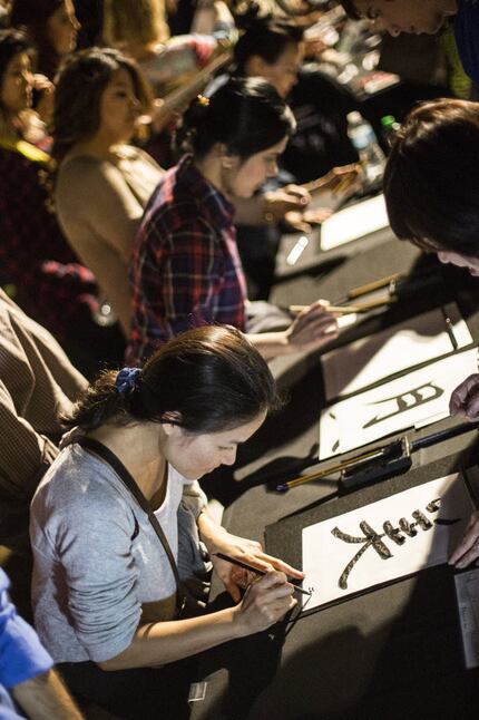 Jennifer Phan writes her name on a piece of calligraphy she created during the Otsukimi Moon...
