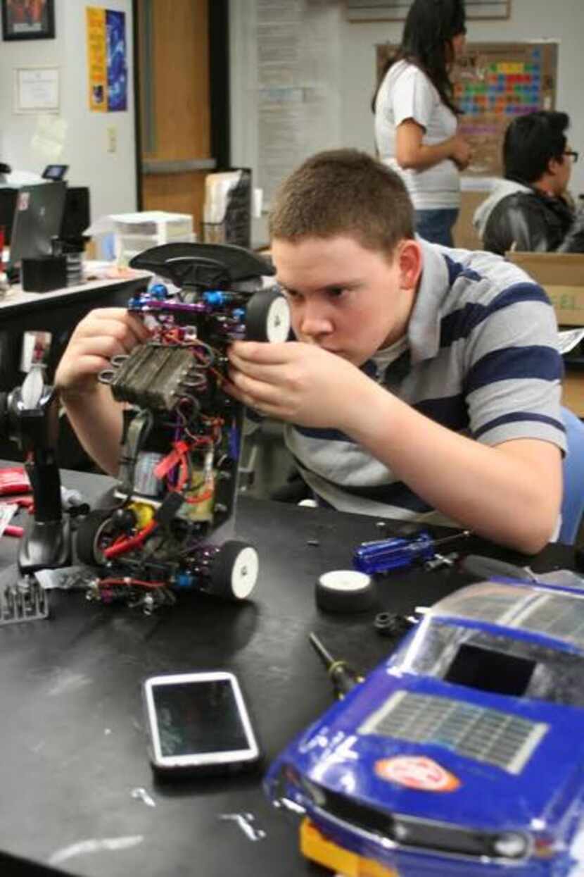 
Bullis prepares a radio-controlled car for a lap around the track during Student Racing...