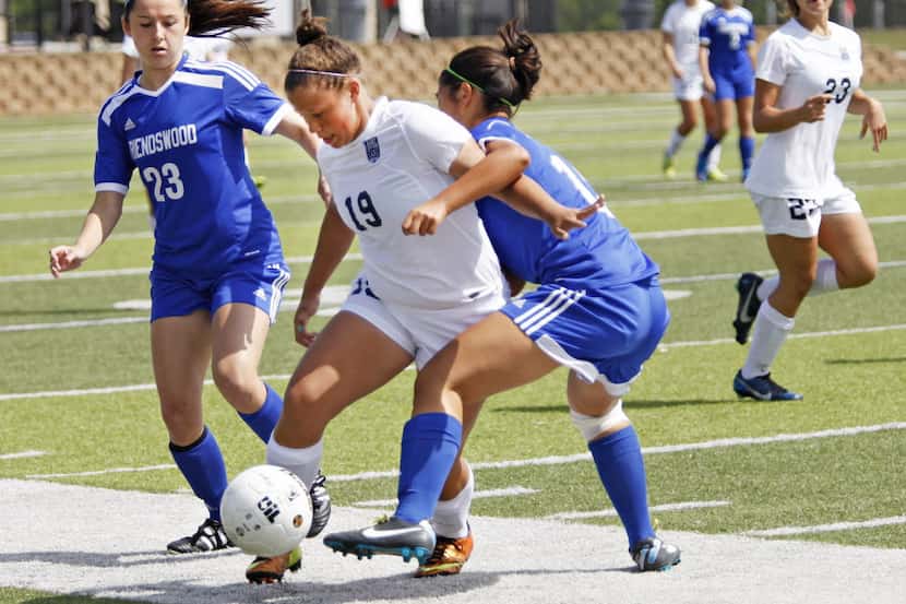Wylie East player Asia Revely (19) tries to break in between Friendswood player Kori...
