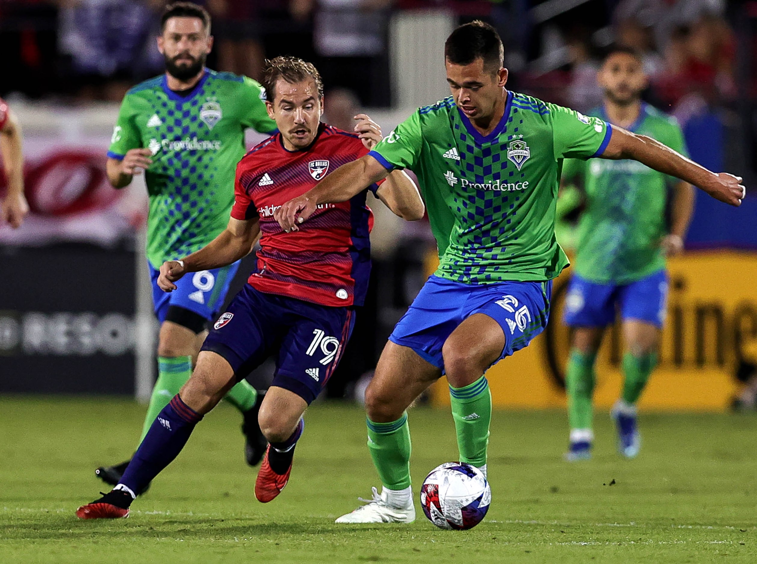 Seattle defender Jackson Ragen (25) tries to keep the ball away from FC Dallas midfielder...