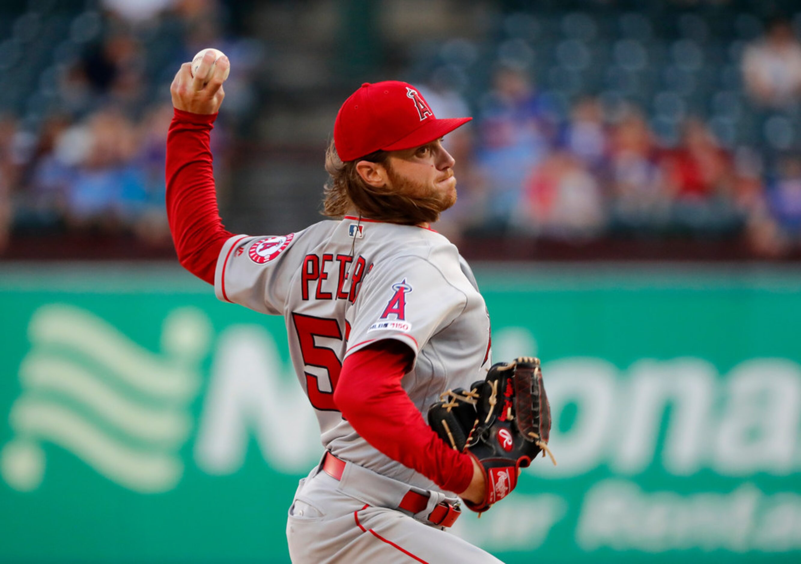 Los Angeles Angels starting pitcher Dillon Peters throws to the Texas Rangers in the first...