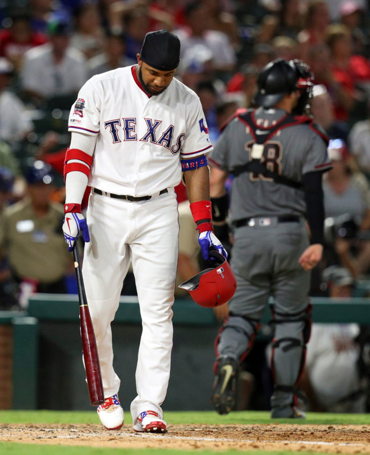 Texas Rangers' Elvis Andrus walks away after striking out to end the fifth inning of the...