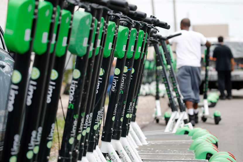 Lime scooters are shown outside a warehouse in Dallas in 2020.