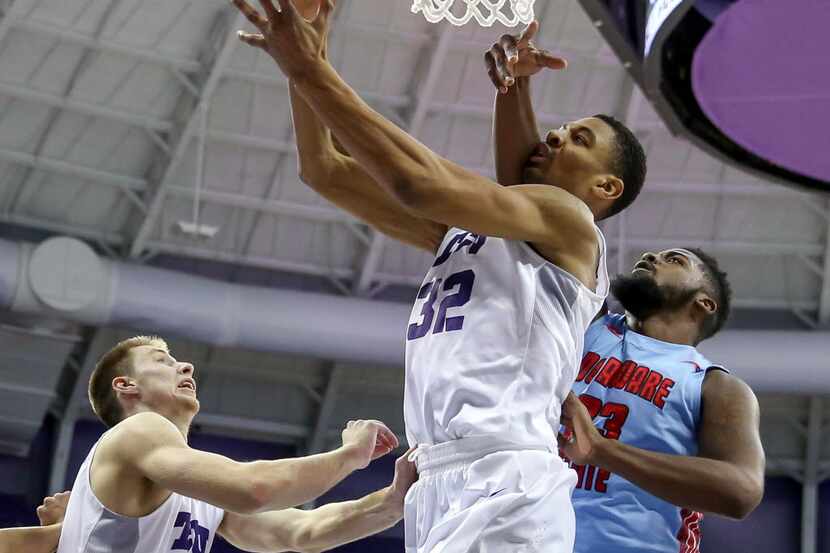 TCU forward Karviar Shepherd (32) draws a foul on Delaware State Jason Owens (23) during the...