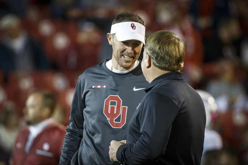 Oklahoma head coach Lincoln Riley chats with TCU head coach Gary Patterson before an NCAA...