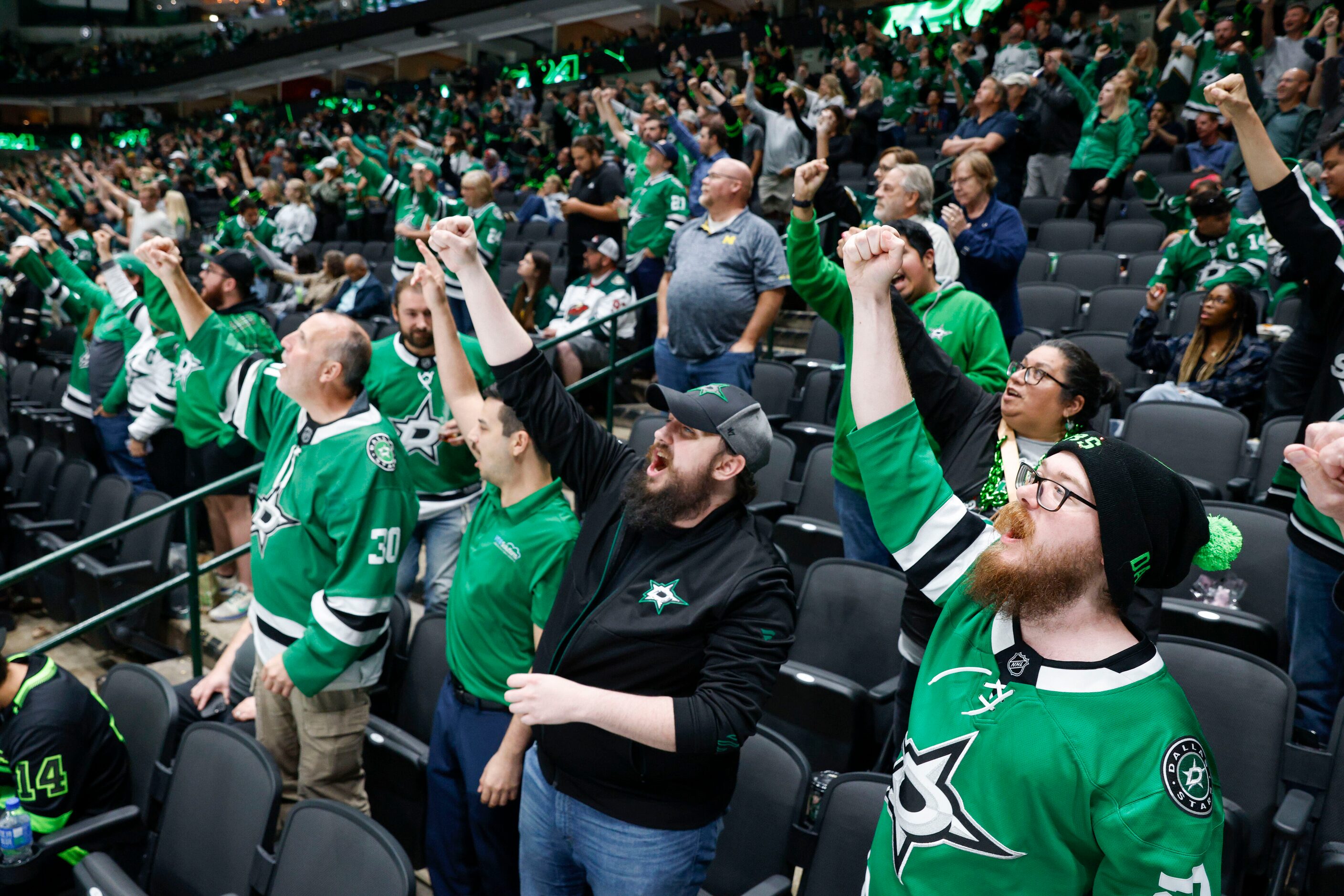 Dallas Stars fans celebrate a goal during the third period of an NHL preseason game against...