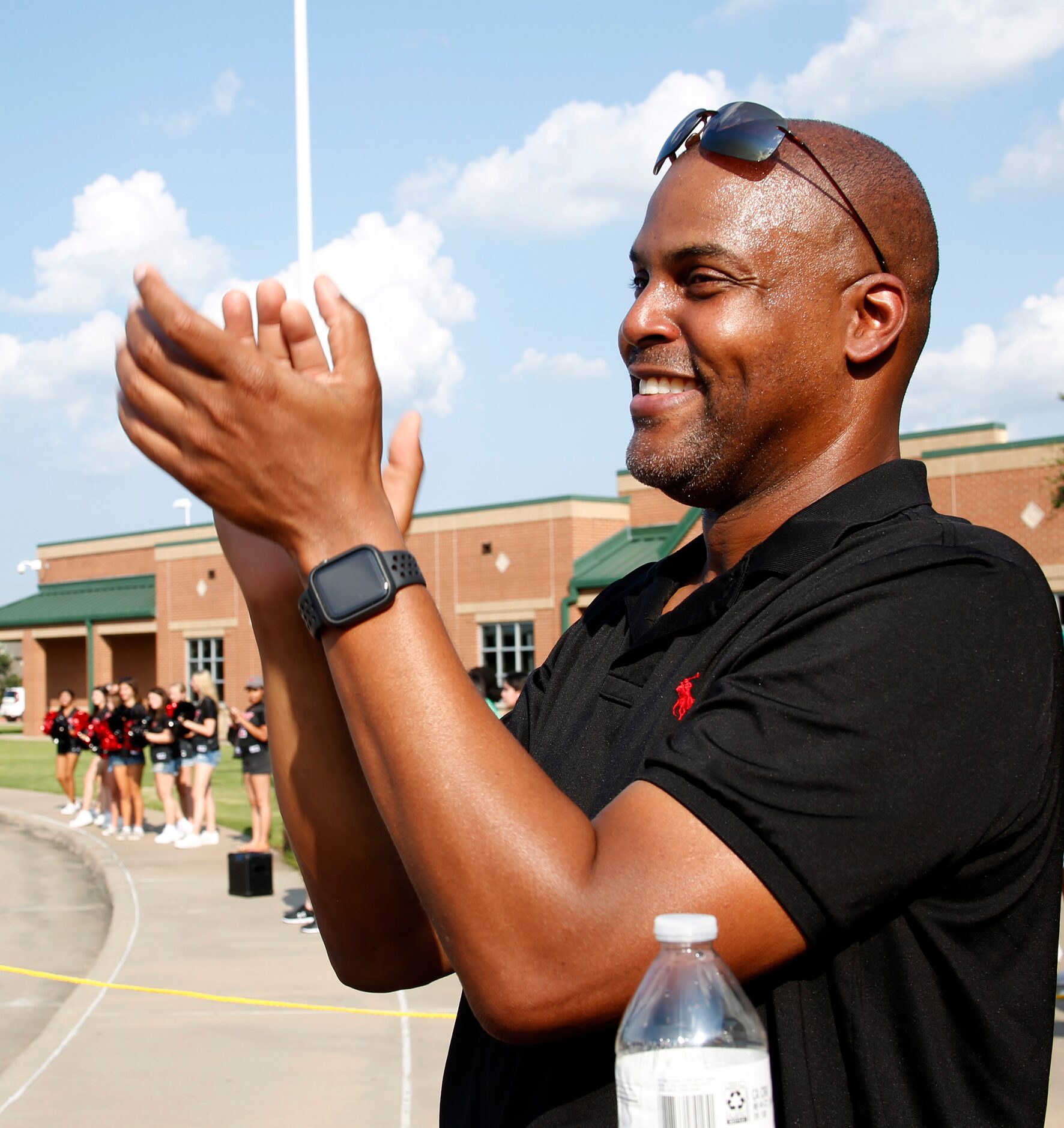 Earl Moore applauds as a caravan of cars arrive to show their support for his daughter,...