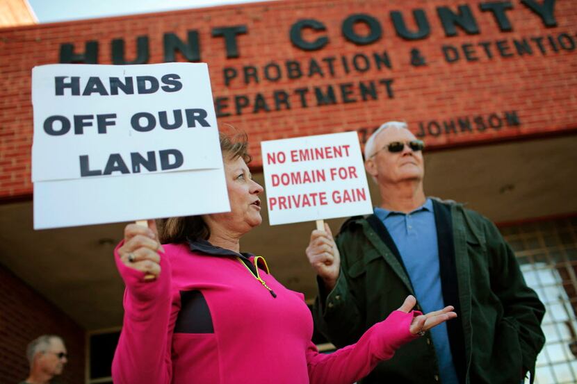  Kathy Carrell and her husband Mike Carrell from Caddo Mills, Texas hold signs in protest of...