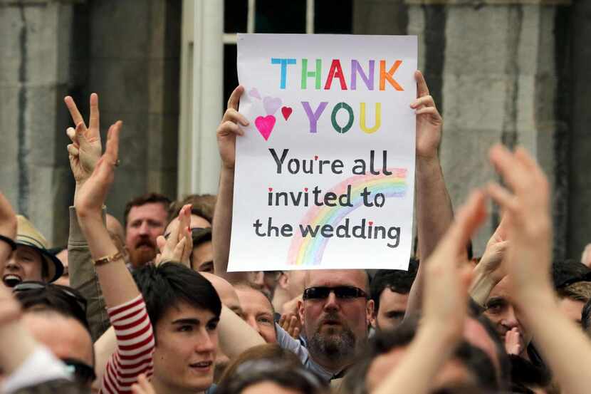
A supporter holds a sign outside Dublin Castle following the result of the same-sex...