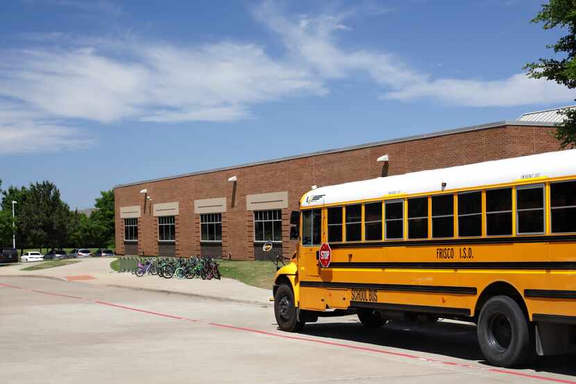 A bus parks for students at Isbell Elementary School in Frisco on April 26, 2019.