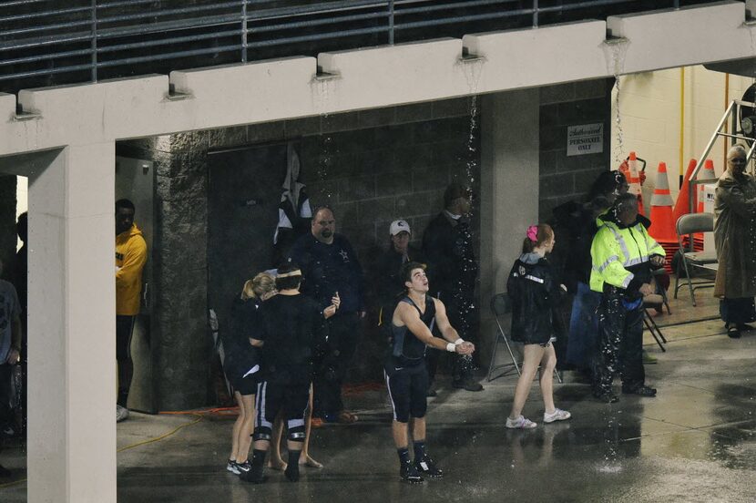 Guyer junior running back Tucker Nitary (37) catches rain water draining from a walkway in...