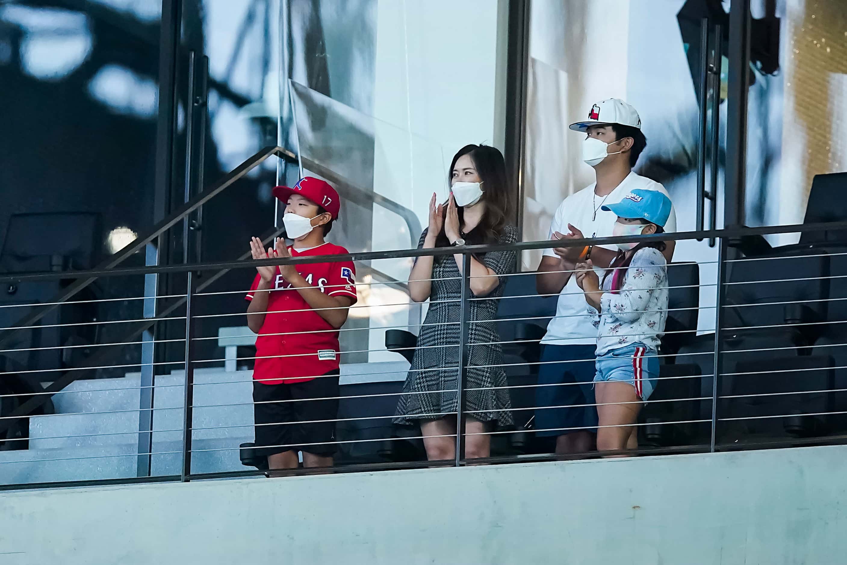 The family of Shin-Soo Choo, from left Aiden, Won Mi Ha, Allan and Abigail, applaud a video...