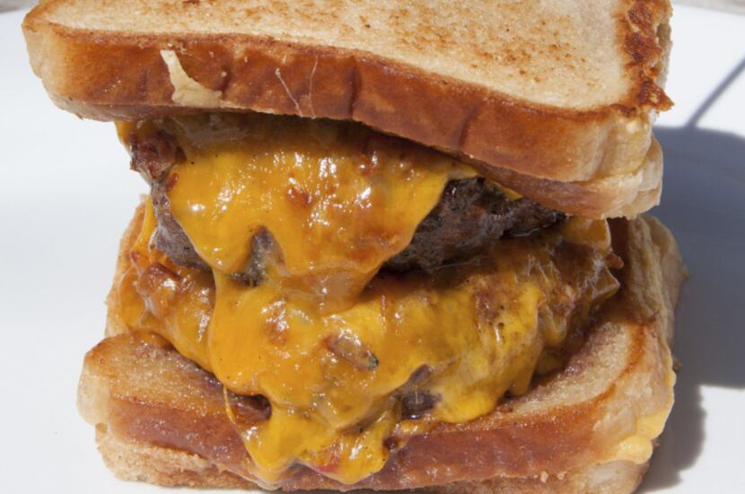 Grilled cheese sandwiches serve as the buns for the Double-Dougie Add Bacon burger at Burger...