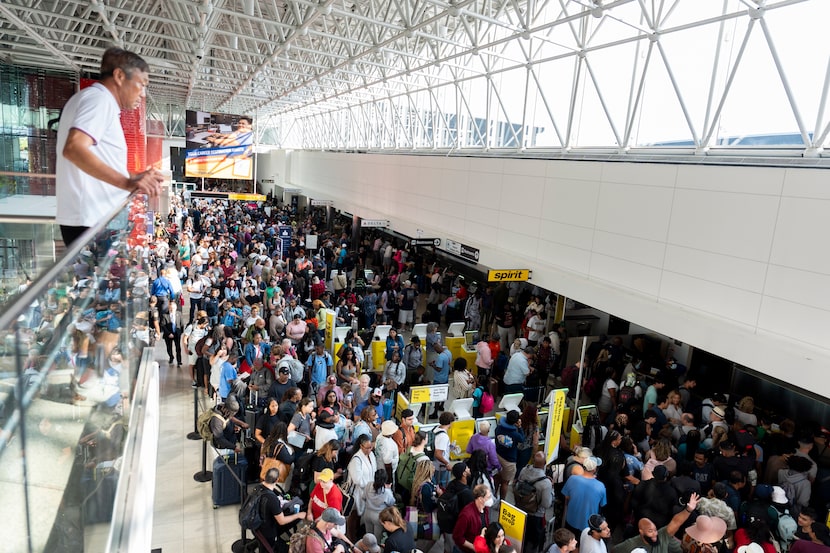 Travelers wait in line at Baltimore/Washington International Thurgood Marshall Airport in...