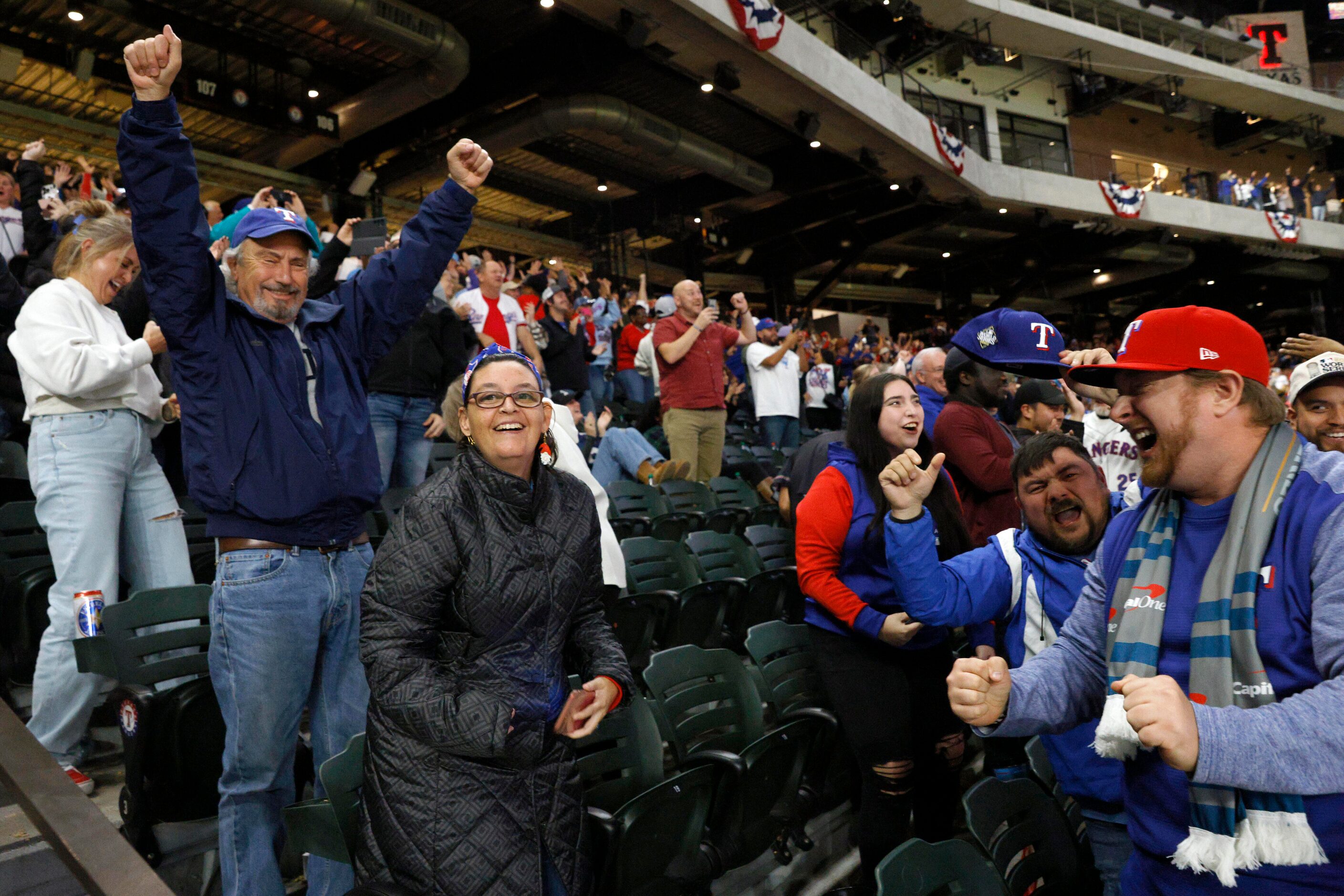 Fans celebrate after the Texas Rangers won Game 3 of the World Series against the Arizona...