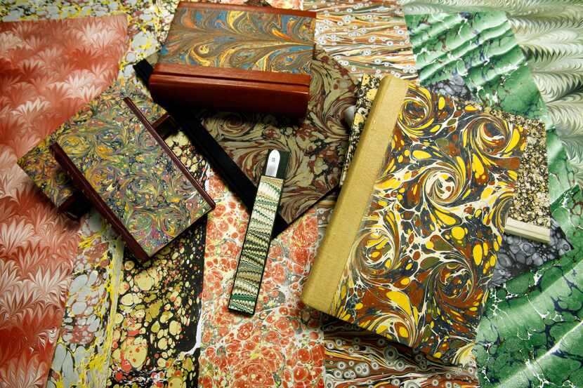 Cathrerine Levine's paper marbling is used to cover books at the Craft Guild of Dallas. The...
