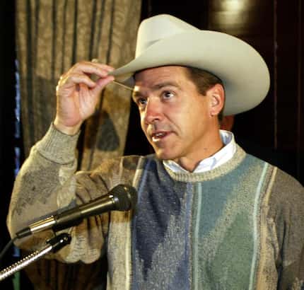 From this 2002 file photo, LSU football coach Nick Saban tries on a cowboy hat presented to...