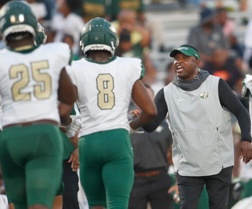 DeSoto head coach Claude Mathis congratulates Khylan Mosely (8) following an Eagles...