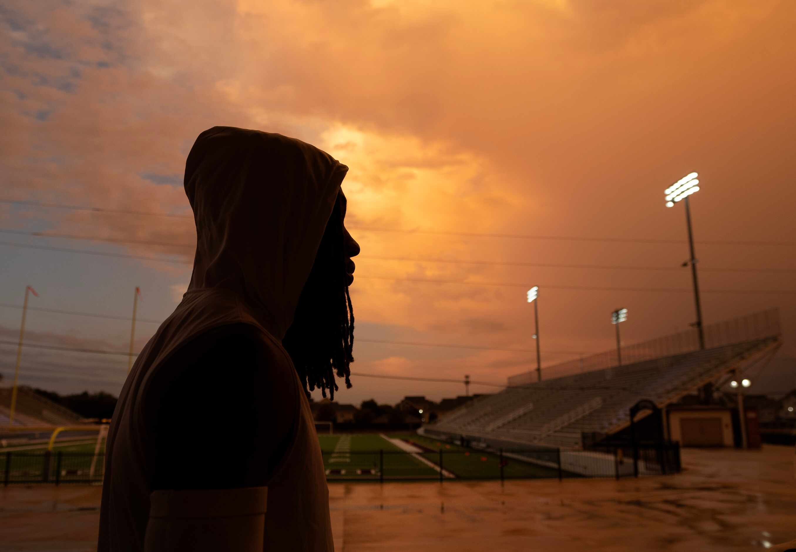 South Oak Cliff senior wide receiver Adem Madise checks the weather during a lightning delay...
