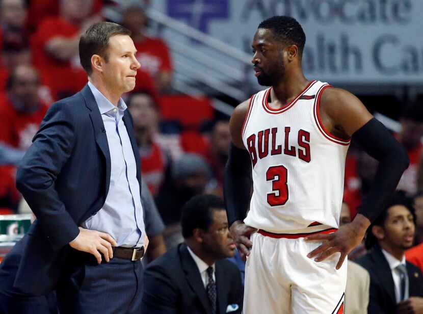 Chicago Bulls head coach Fred Hoiberg, left, talks with guard Dwyane Wade during the first...