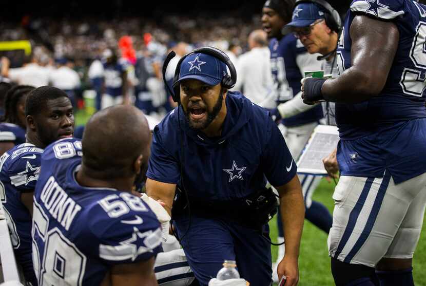 Dallas Cowboys passing game coordinator and defensive backs coach Kris Richard (center),...