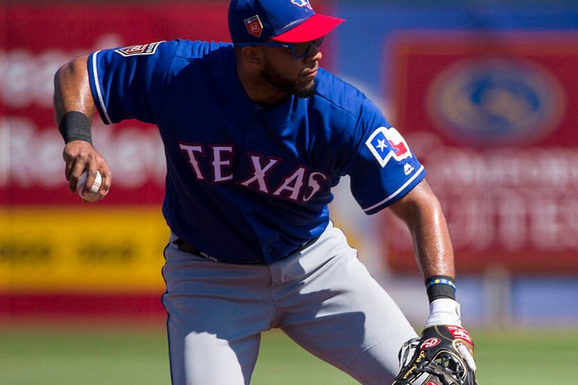 Texas Rangers shortstop Elvis Andrus makes the play on a grounder by Cleveland Indians...