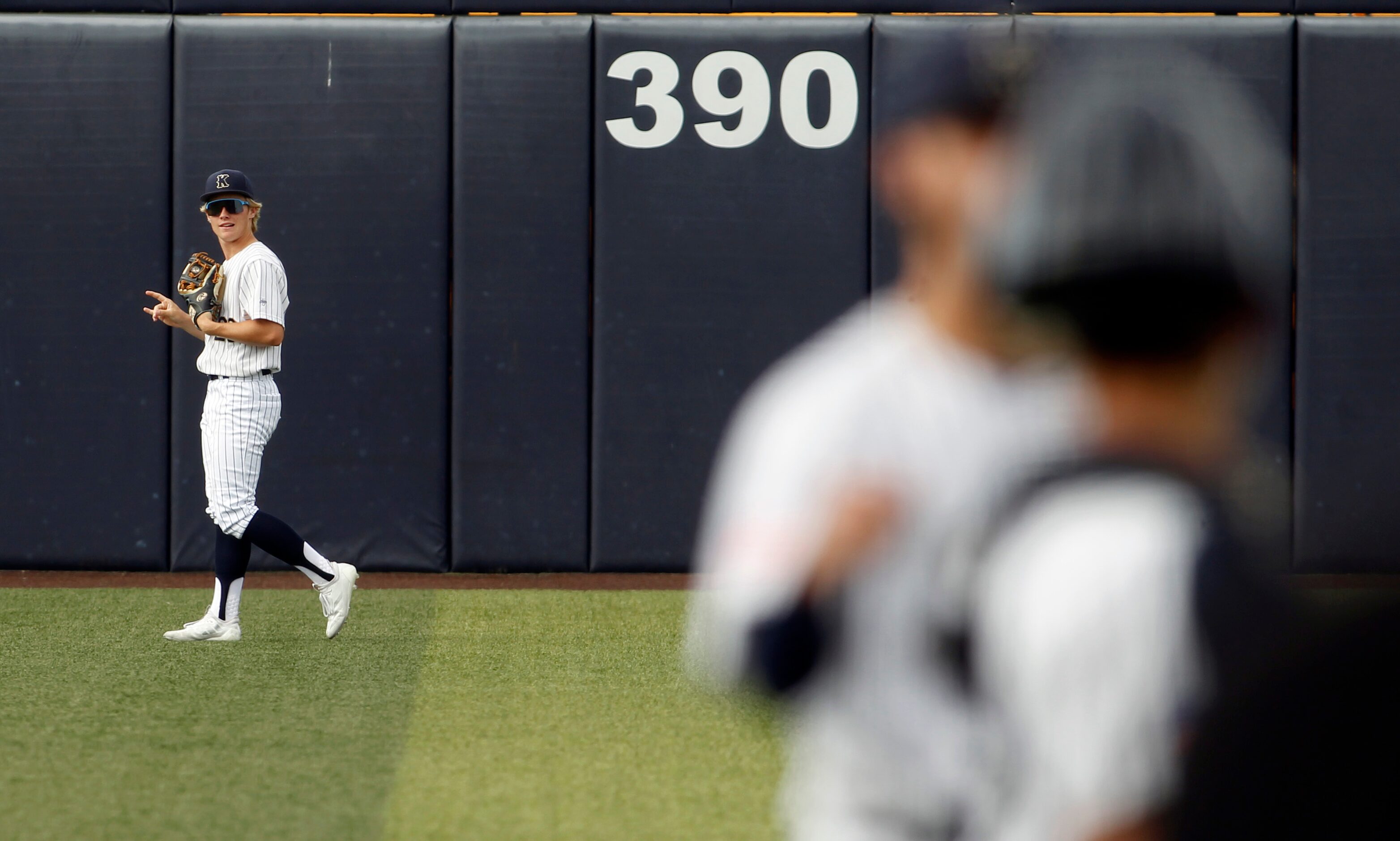 Keller center fielder Brock Burkett (26) gestures toward the dugout after making a leaping...