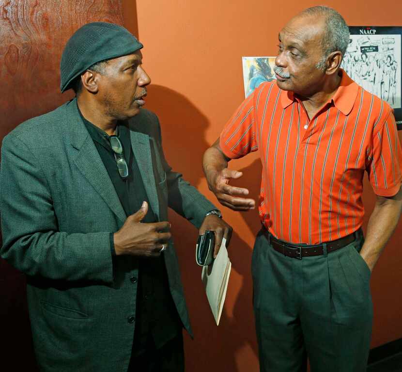 
Clarence E. Glover Jr. (left) talks to civil rights advocate Peter Johnson at his office in...