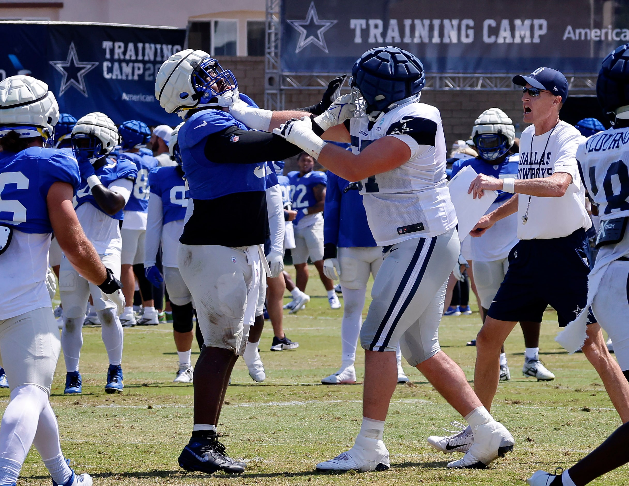 Dallas Cowboys center Brock Hoffman (67) locks up with Los Angeles Rams defensive tackle...