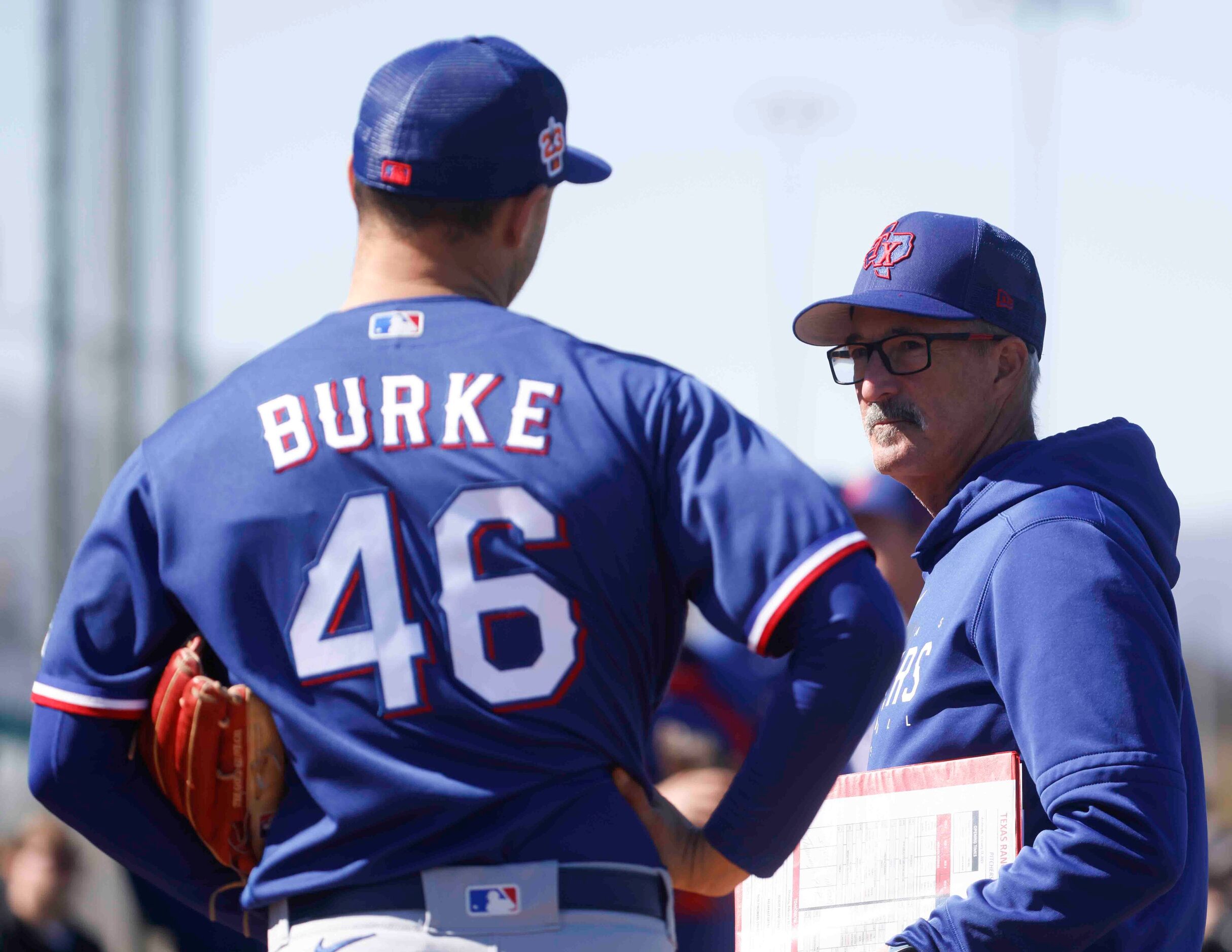 Texas Rangers pitching coach Mike Maddux, right,  listens to Texas Rangers left handed...