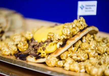 Here's a new Rangers item: the Popcornopolis Pita, a smoked brisket sandwich topped with mac...