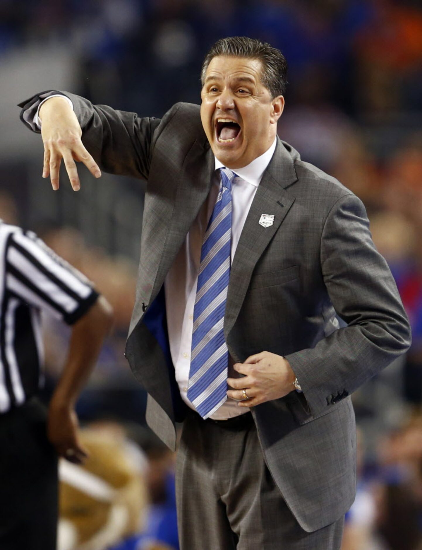 Kentucky Wildcats head coach John Calipari signals to his players during the second half of...