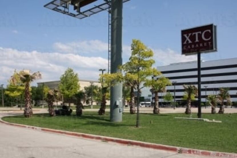 A sign for the XTC Cabaret on Stemmons Freeway.