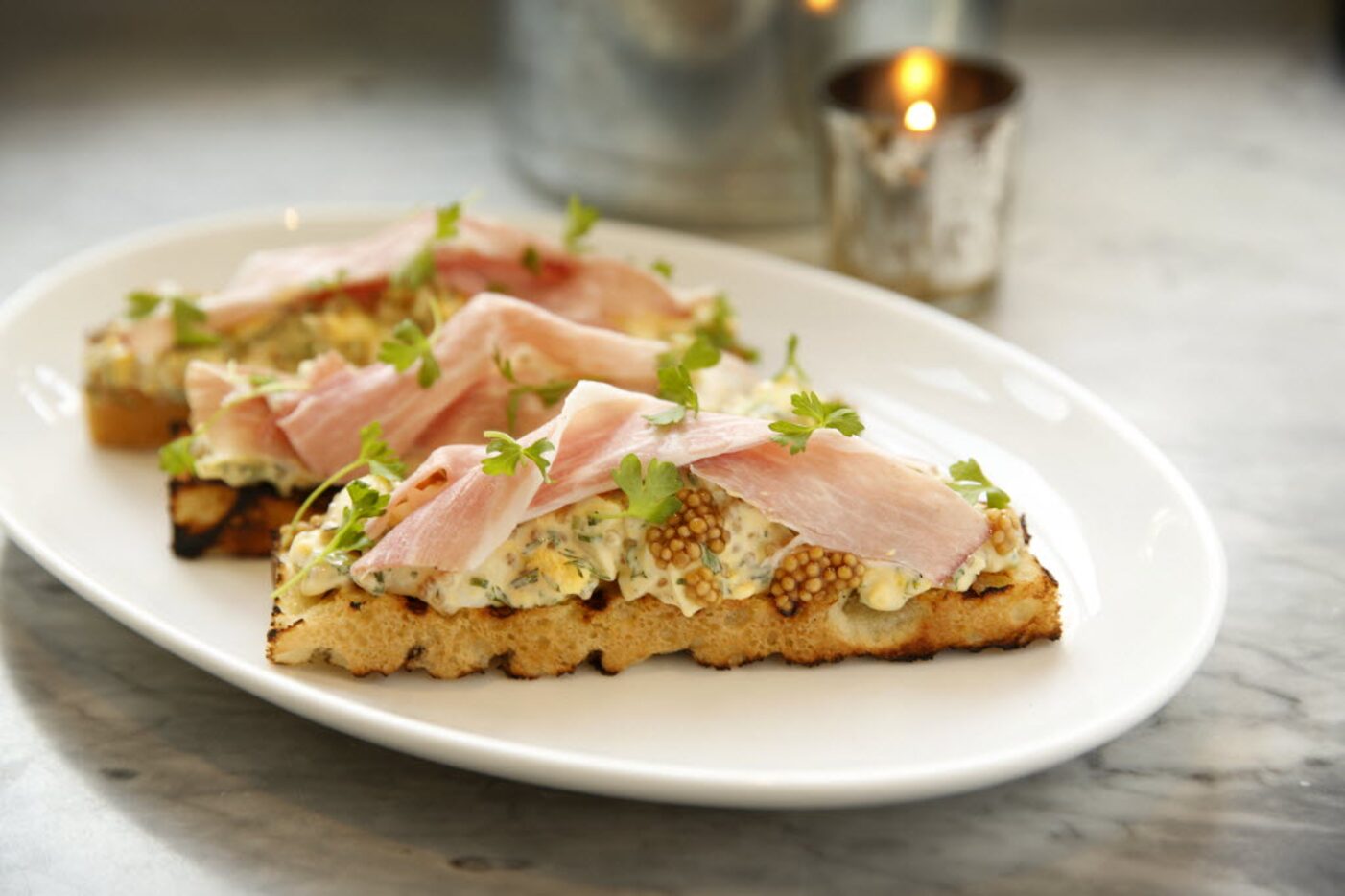 Deviled egg salad and ham on ciabatta toast 