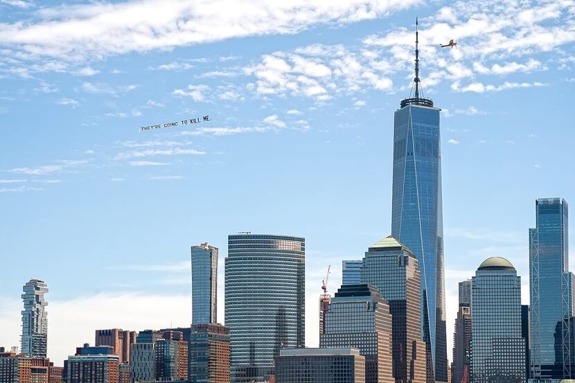 A banner reading "They're going to kill me," which were among George Floyd's last words,...