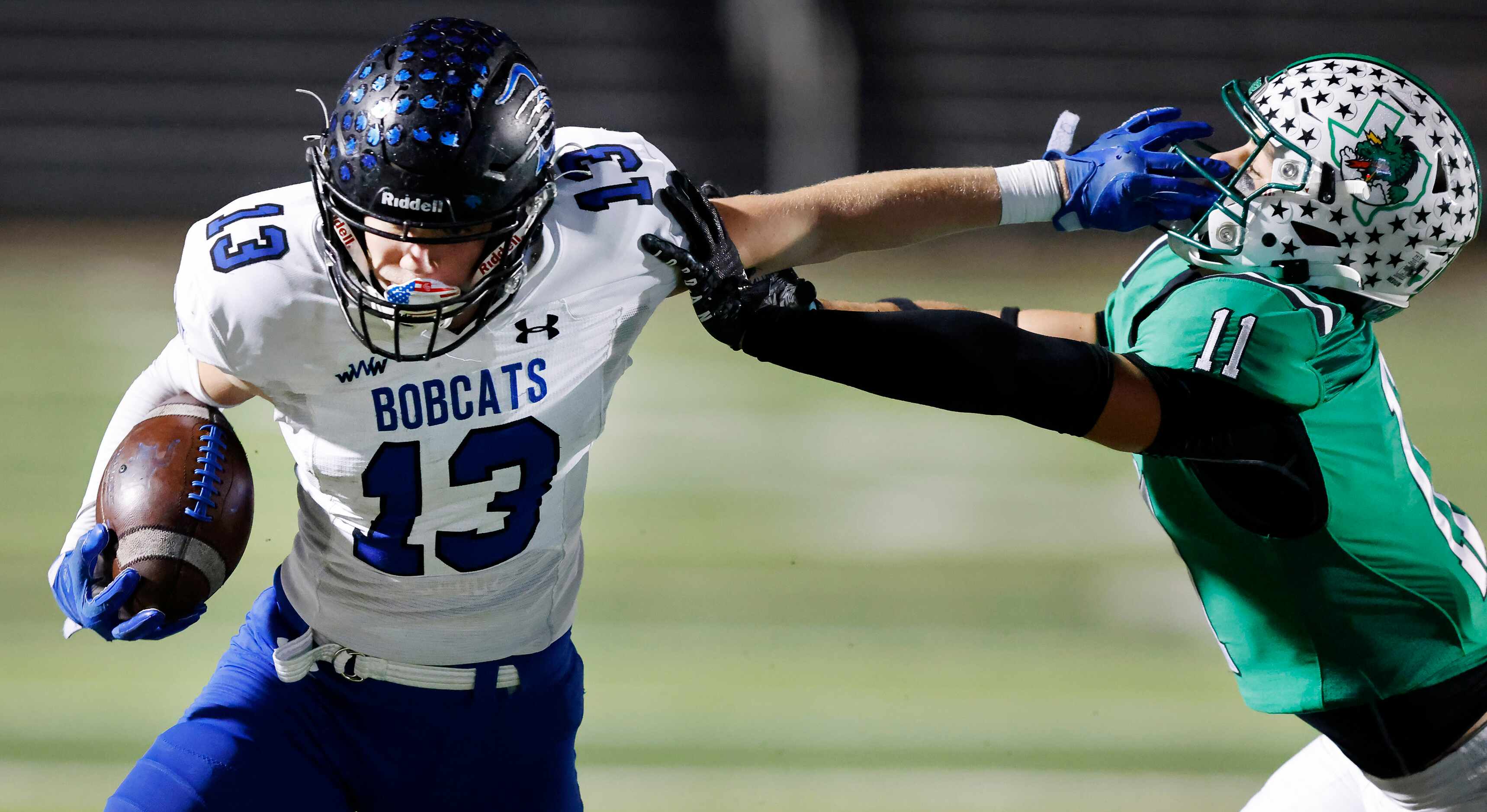Byron Nelson receiver Gavin McCurley (13) gives a stiff arm to Southlake Carroll define back...