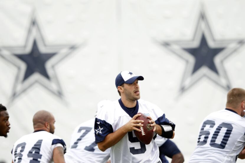 Dallas Cowboys quarterback Tony Romo (9) prepares to throw the ball during a drill during...