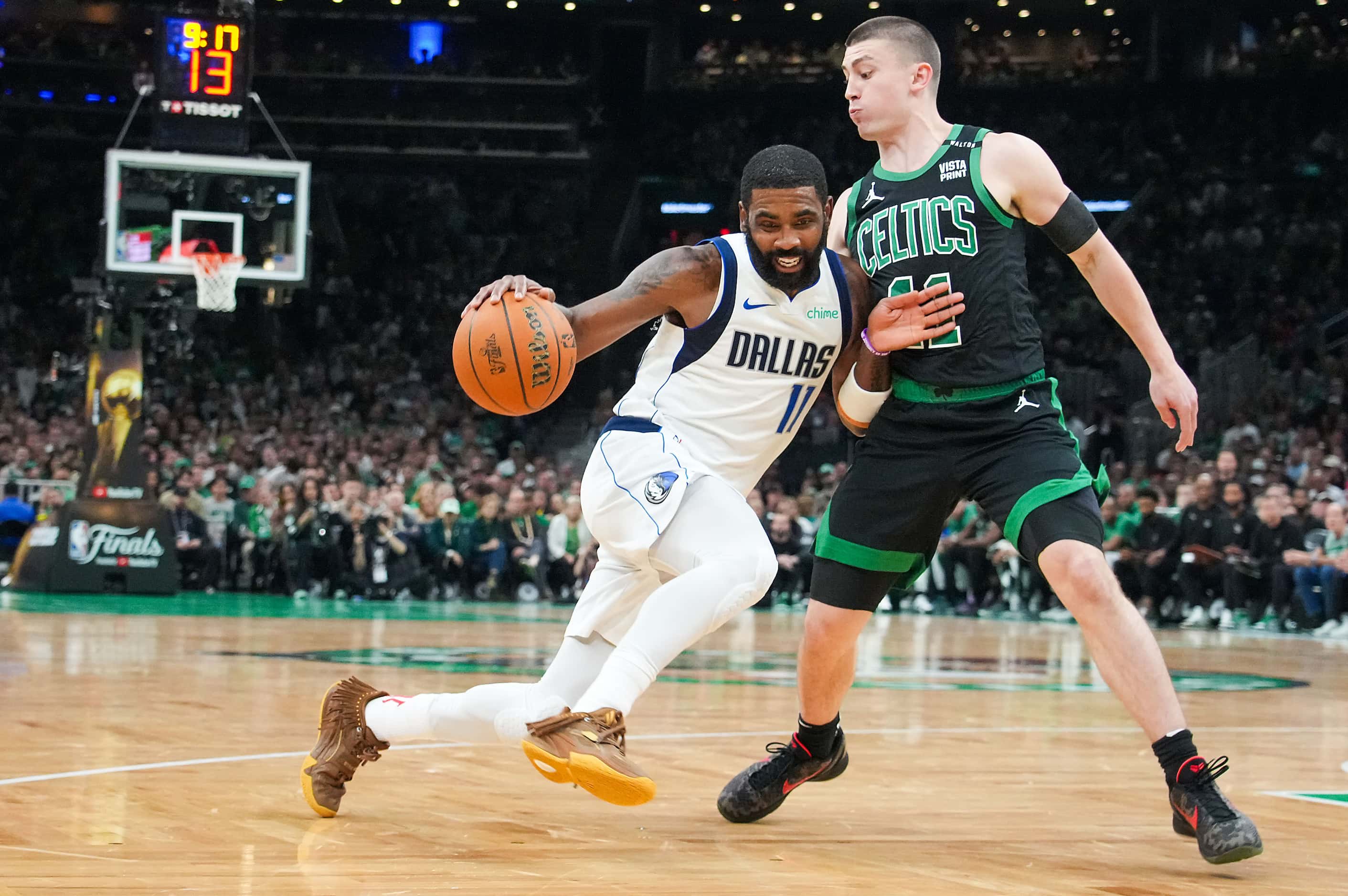 Dallas Mavericks guard Kyrie Irving (11) drives against Boston Celtics guard Payton...