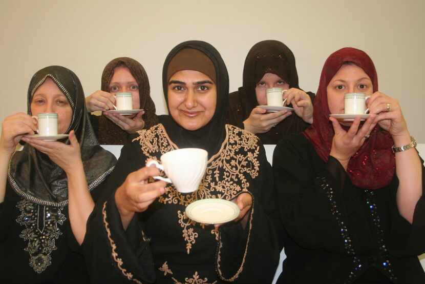 Rohina Malik (center) portrays five tea-sipping Muslim women from different backgrounds in...