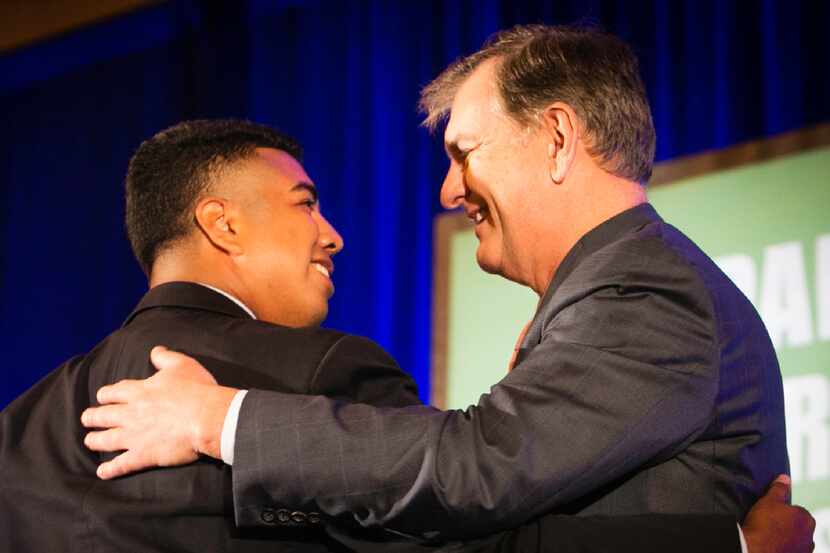 Former Mayors Intern Fellow Adan Gonzalez hugs Dallas Mayor Mike Rawlings before delivering...